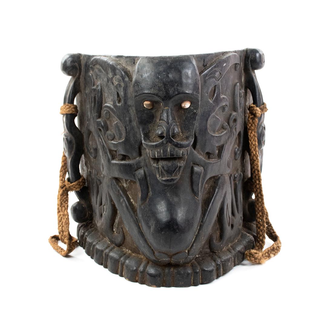 Indonesia Borneo Bahau-Busang Hawat or Baby Carrier: Indonesia Borneo Dayak Aristocratic Bahau-Busang hawat or baby carrier (19th Century), deeply carved wood and fiber back carrying straps, conus shell eyes having carved central motif of an "Aso" a typ