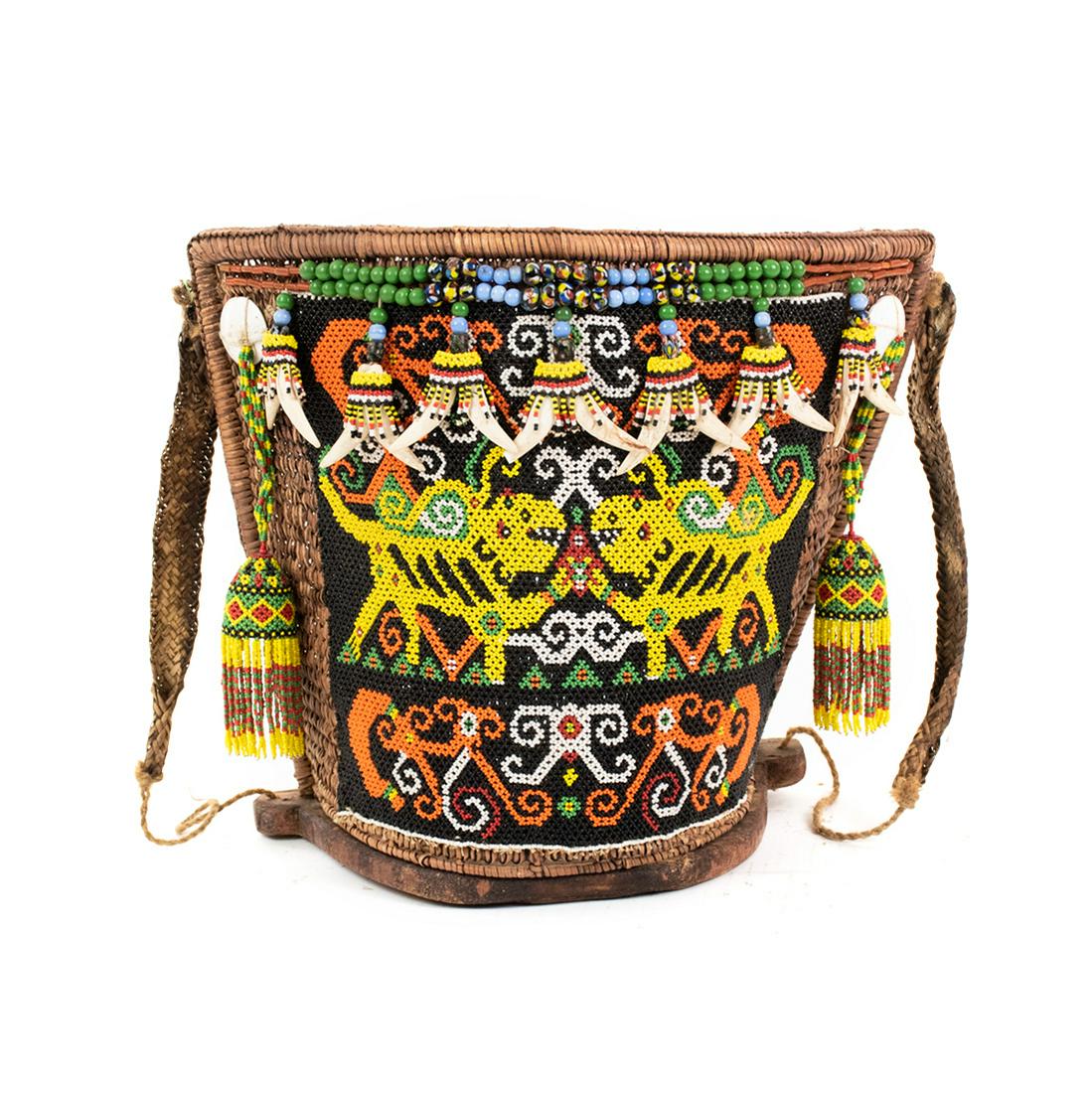 Indonesia Borneo Kenyah Dayak Ba Beaded Baby Carrier: Indonesia Central Borneo Kenyah Dayak Ba or baby carrier (Mid 20th Century) constructed of woven rattan with a wooden crescent shaped base and fine detailed beadwork designs in orange, yellow, white,
