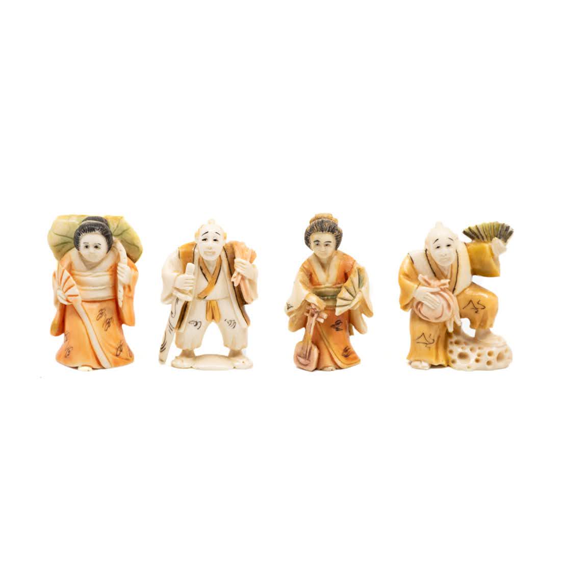 Four Japanese Painted Carved Bone Netsuke Figures: Four Japanese carved bone netsuke figures; one female geisha carrying green parasol and hand fan in orange tinted robe; one male samurai carrying samurai sword; one male samurai figure with pouch in o