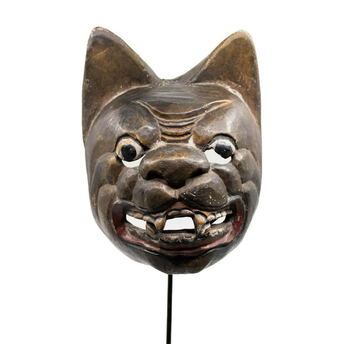 Indonesian Topeng Panther Mask: Indonesian Topeng panther wood mask having black painted face with slightly open mouth and visible teeth shown. There are small eye slits and opened mouth. Mounted with stand.