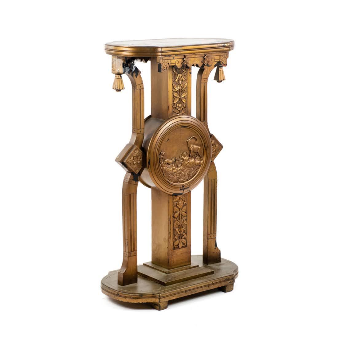 East Lake Victorian Plant Stand Pedestal: An Eastlake style Victorian (Late 19th Century) gold painted ebonized wood plant stand or pedestal having carved reliefs of flowers and rectilinear designs with large center medallion different nature