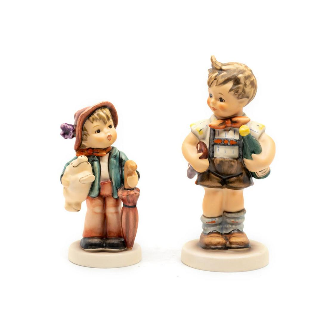 Goebel Hummel Lucky Boy 335 and Valentine Joy 399: Goebel Hummel #402 Lucky Boy TMK 7 features a boy with a smiling pig and an umbrella, limited edition 3480 of 2500, #399 Valentine Joy TMK 6 is a special edition 4 that features a boy carrying a heart