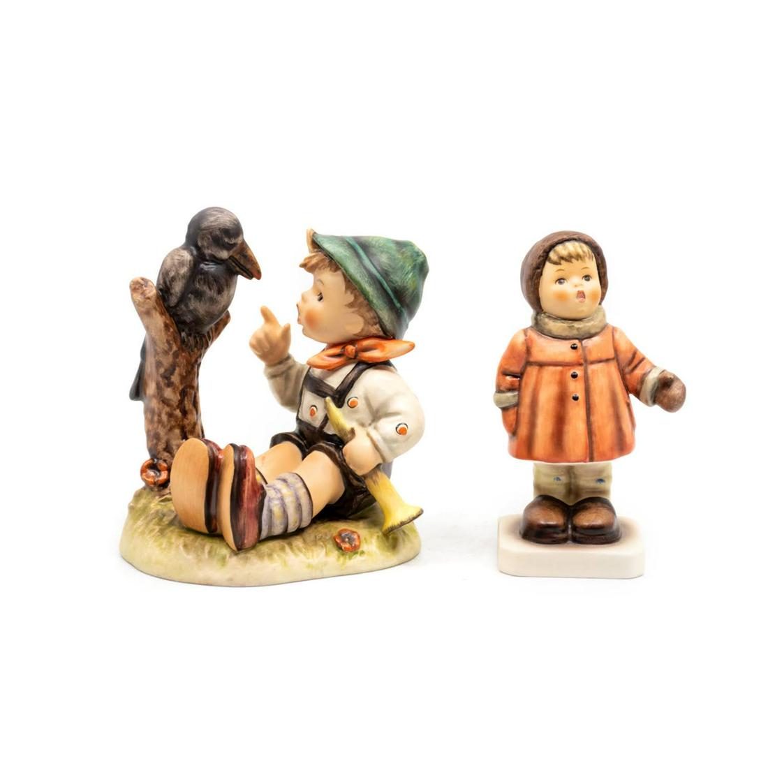 Goebel Hummel Sing Along 433 and Winter Song 476: Goebel Hummel #433 Sing Along TMK 6 features a boy singing to a crow with a horn in his hand, #476 Winter Song TMK 7 features a girl singing in a winter coat and mittens.