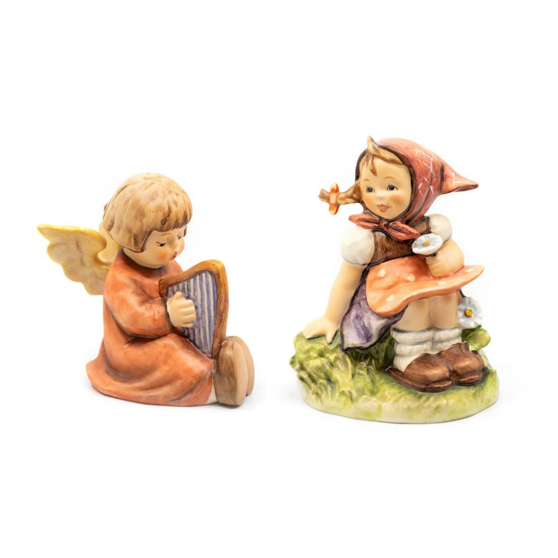 Goebel Hummel In the Meadows 459 and Song of Praise 454: Goebel Hummel #459 In the Meadow TMK 6 features a girl sitting in a meadow while holding a daisy, #454 Song of Praise TMK 6 features an angel singing and playing the harp.