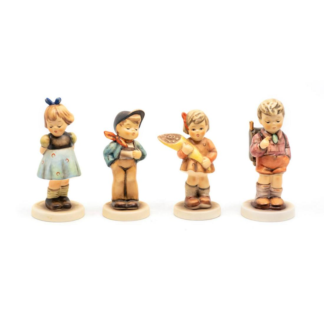 Group of 4 Goebel Hummels including Lucky Fellow 570: Goebel Hummel #493 Two Hands One Treat TMK 7 features a girl with her hands clasped behind her back, #570 Lucky Fellow TMK 7 features a boy with suspenders and a hand in his pocket, #549 A Sweet Offer