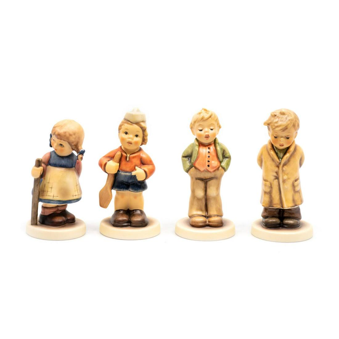 Group of 4 Goebel Hummels including Pixie 768: Goebel Hummel #768 Pixie TMK 7 features a winking girl walking with a stick, #2148/B First Mate TMK 8 features a boy in a sailor's cap holding an oar, #848 Steadfast Soprano TMK 8 features a boy singi