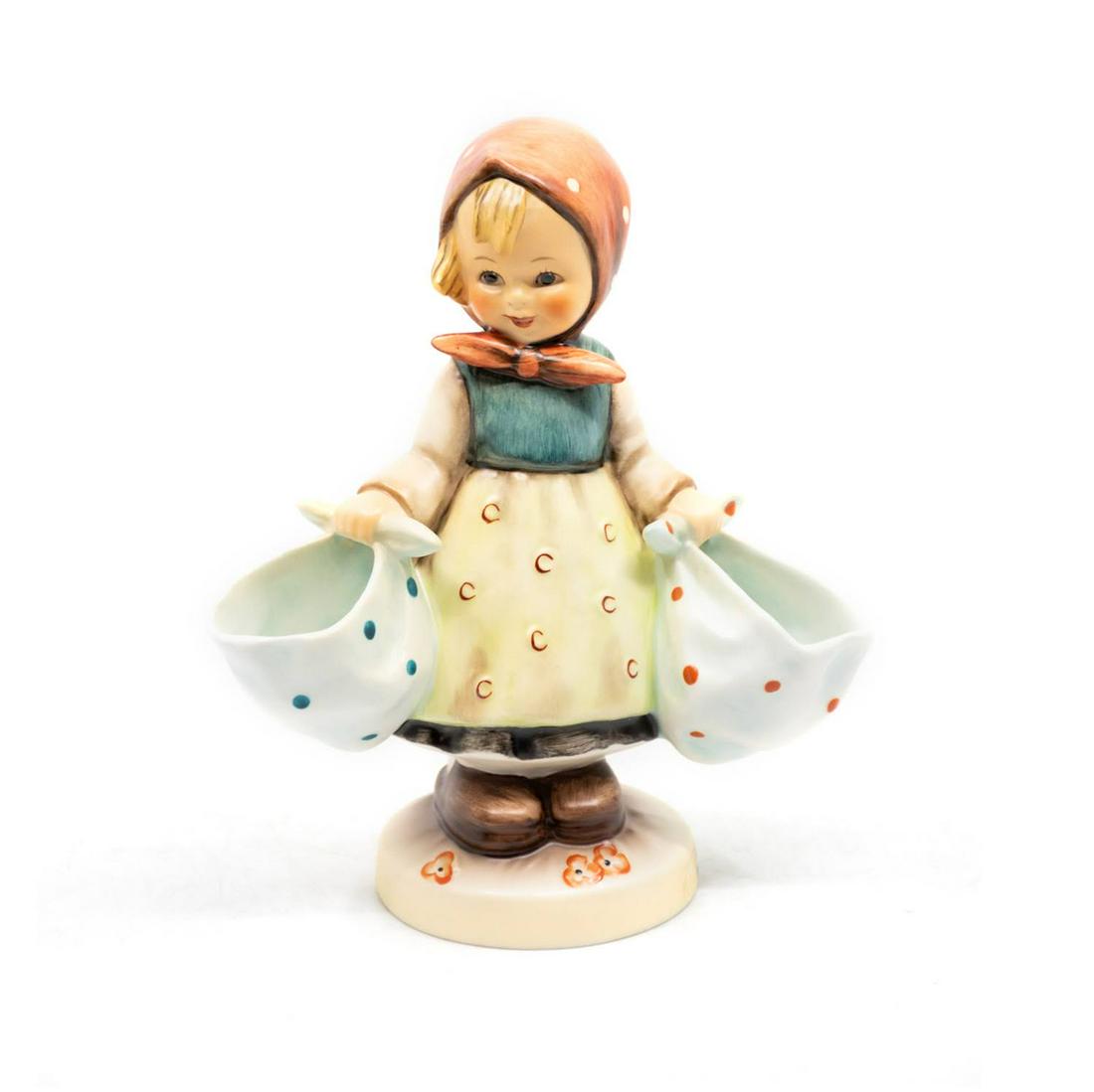 Goebel Hummel Mother's Darling 175 Figurine: Goebel Hummel #175 Mother's Darling TMK 7 features a young girl carrying two bags, one in each hand.