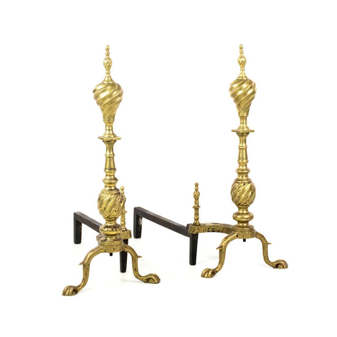 Pair of Chippendale Style Brass Spiral Andirons: A pair of English brass spiral Chippendale andirons having claw feet and spiral form finials.