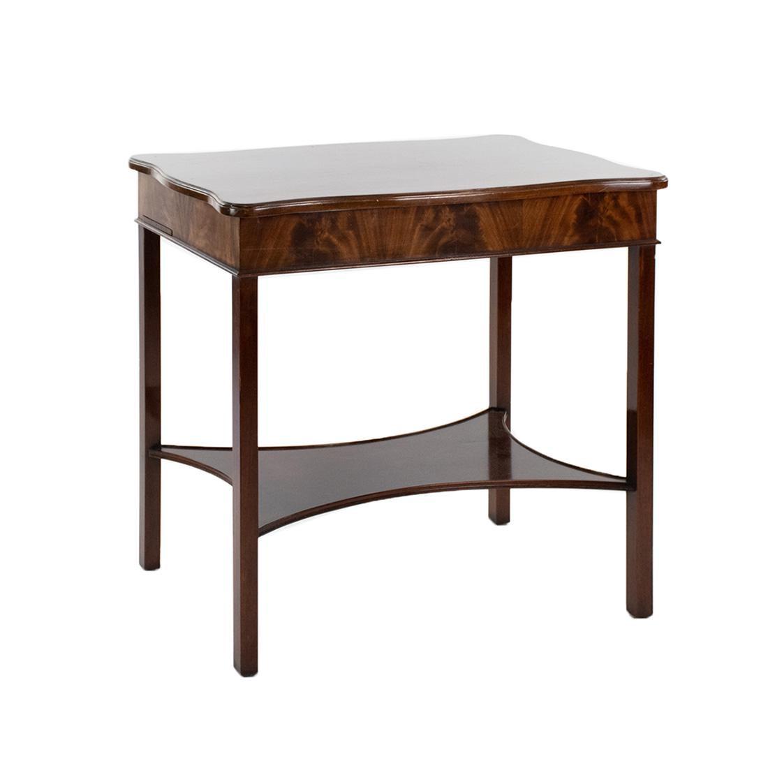 George III Style Mahogany Gentleman's Dressing Table: Early 20th Century George III Style flame mahogany gentleman's dressing table having a flip top with rise and fall mirror two side slide out shelves, and six compartments atop four square legs.