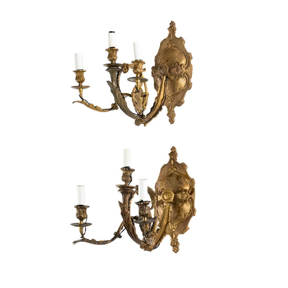 Pair of French Rococo Gilt Bronze Candelabra Sconces: A pair of French Rococo gilt bronze three light candelabra sconces having a shield style backplate and floral decorative features on arms. Sconces have modern wiring.