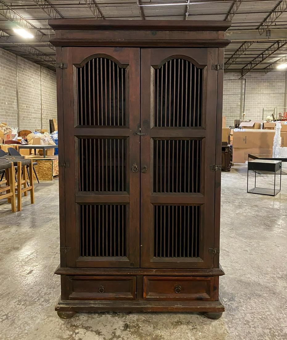 Large Balinese Iron and Wood Wardrobe Cabinet: A large Indonesian Balinese iron and wood wardrobe or wine cabinet having iron slatted doors for ventilation. It features two lower drawers. Unmarked.