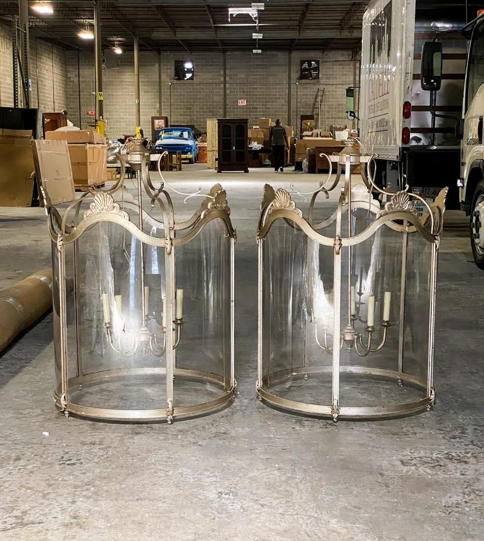 Italian Style Monumental Nickel Round Pendant Lamps: A pair of Italian style contemporary round nickel steel and glass pendant lamps having shell and filigree form motifs atop the glass panels. Both have five arm chandelier style lights inside. Modern w