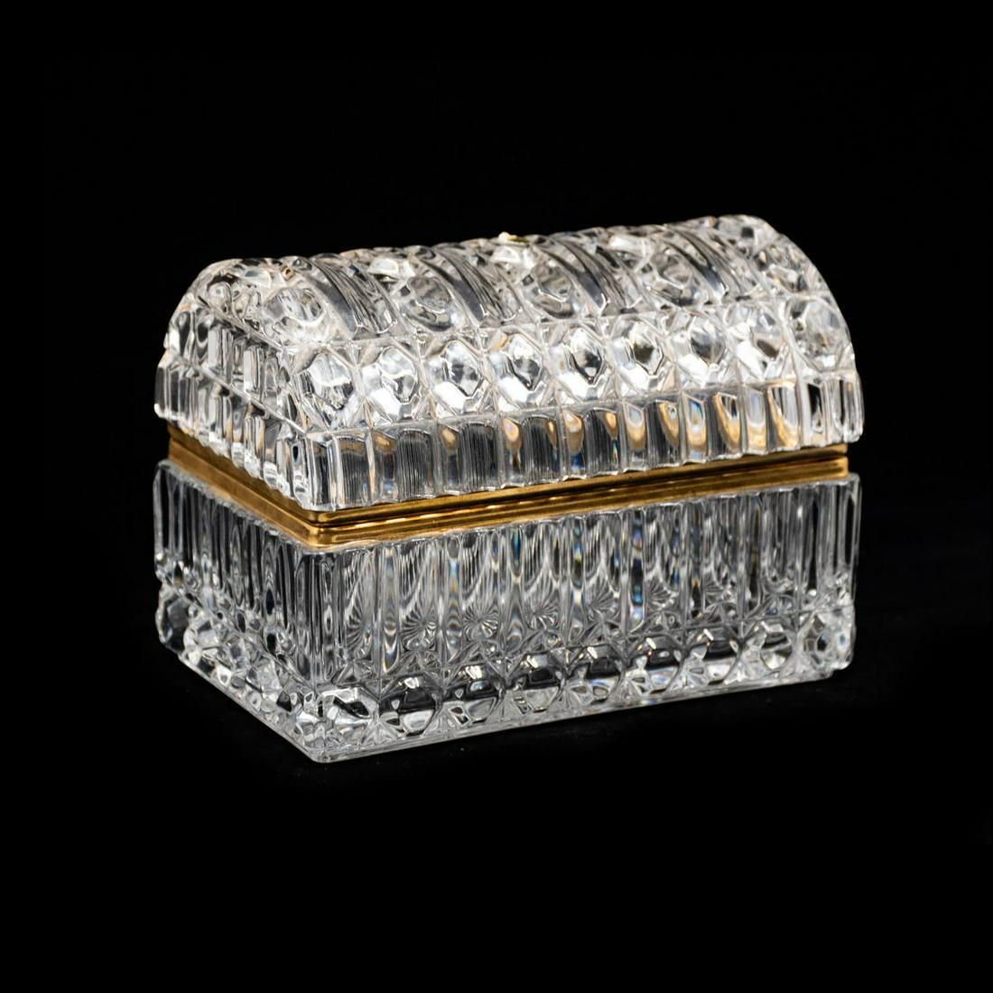 Slovakia Lead Crystal Trinket Box: A vintage Slovakia 24% lead crystal chest shaped trinket box having rounded top and rectangular box. It features a gold tone metal rim around the top and bottom. Sticker on bottom