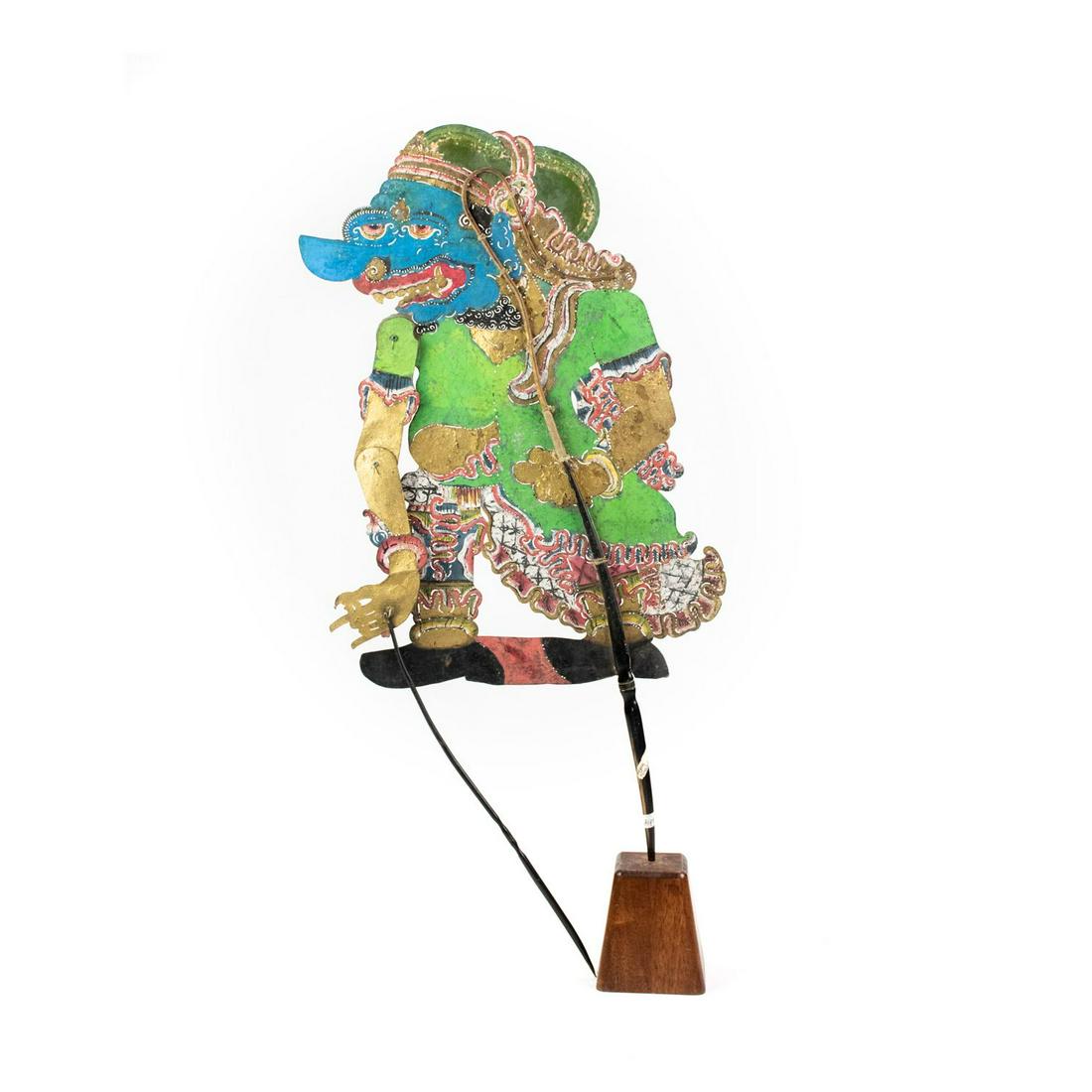 Indonesian Wayang Kulit Hyang Cingkarbala Puppet: An Indonesian Wayang Kulit flat puppet (1920's) intricately hand painted on leather hide. The character Hyang Cingkarbala is depicted with a blue face and green clothing, from the city Semarang. The p