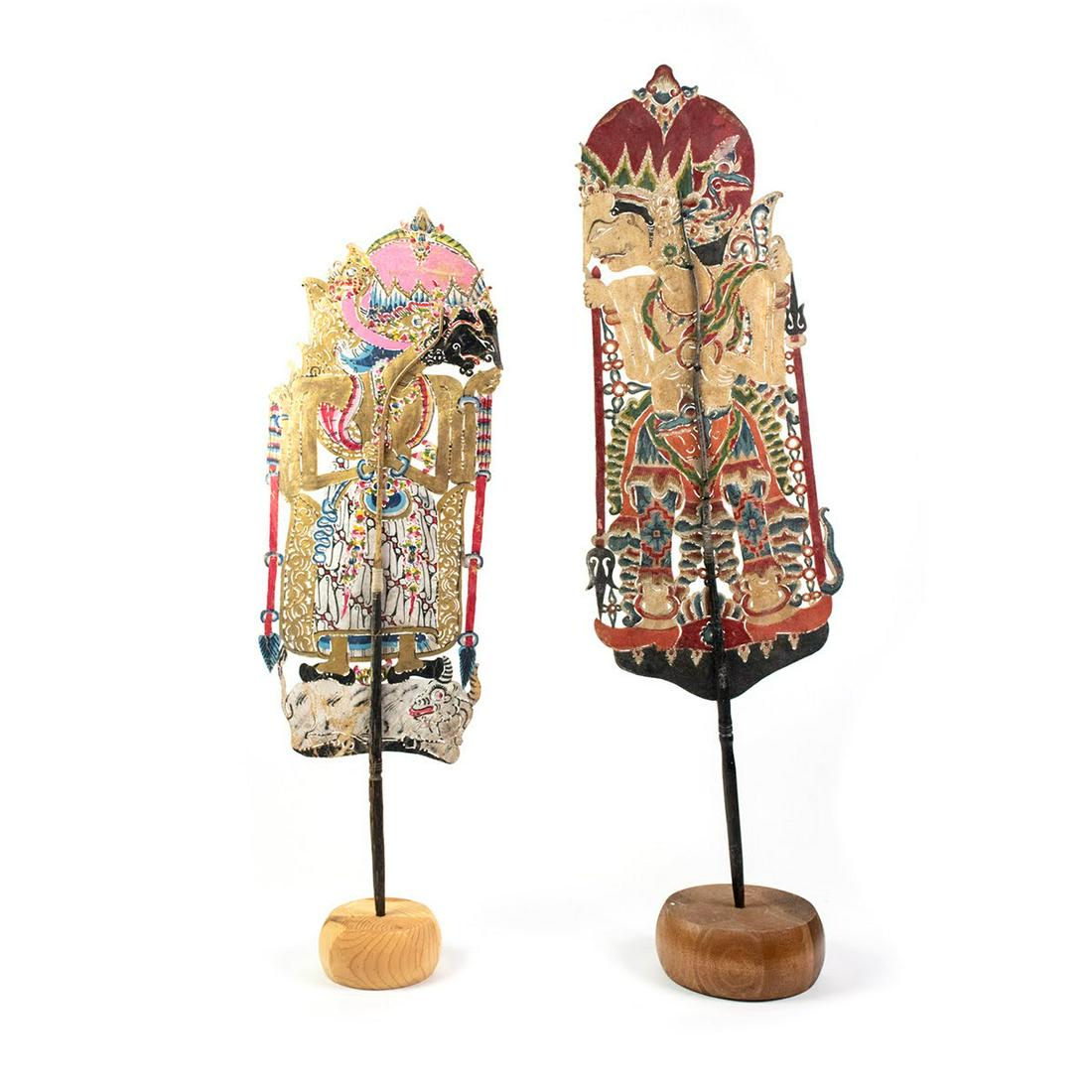 Two Indo Wayang Kulit Betoro Guru & Batara Guru Puppets: A set of two Indonesian Wayang Kulit flat puppets (20th century) intricately hand painted on leather hide representing characters Betoro Guru (left) from Ceper and Betara Guru (right) from Sragen. Eac