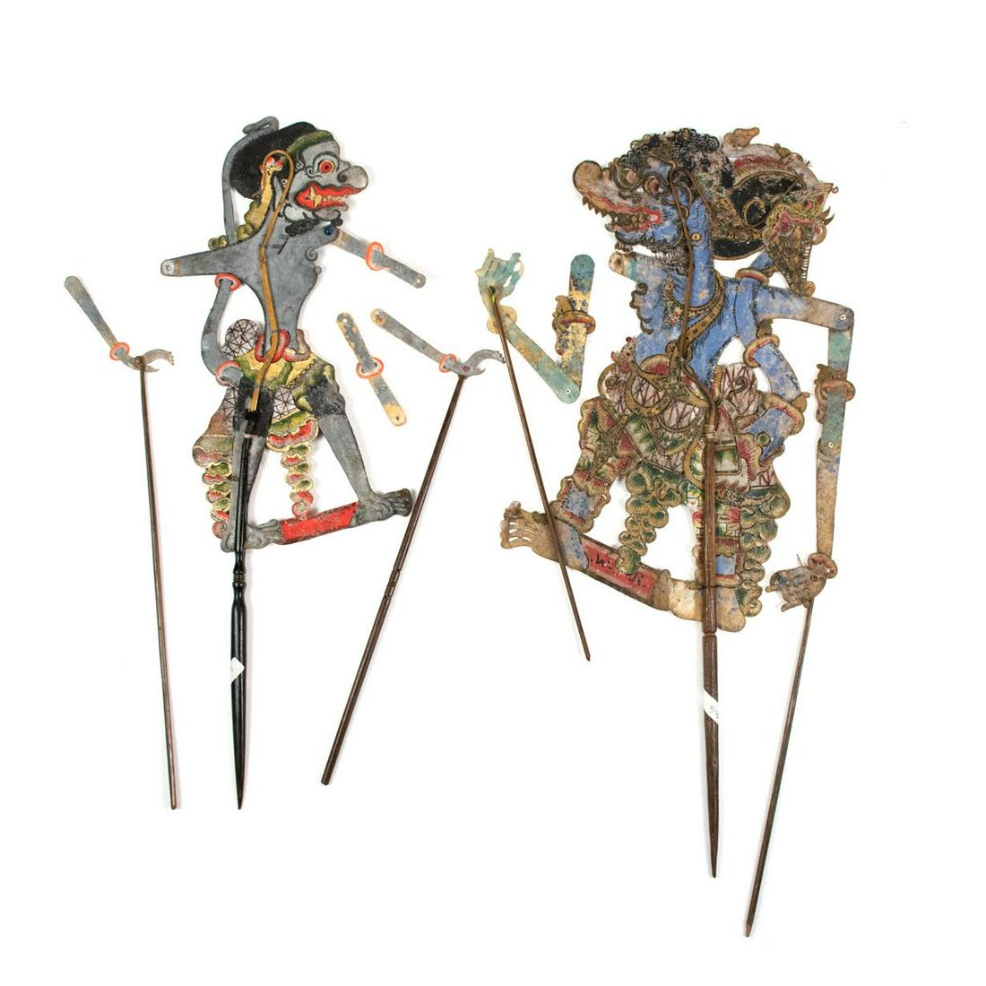 Two Indonesian Wayang Kulit Cengkil & Anilo Puppets: A large scale Indonesian Wayang Kulit flat puppet intricately hand painted on leather hide. The character in unidentifed. The puppet is supported by horn rods on the body and appendages.