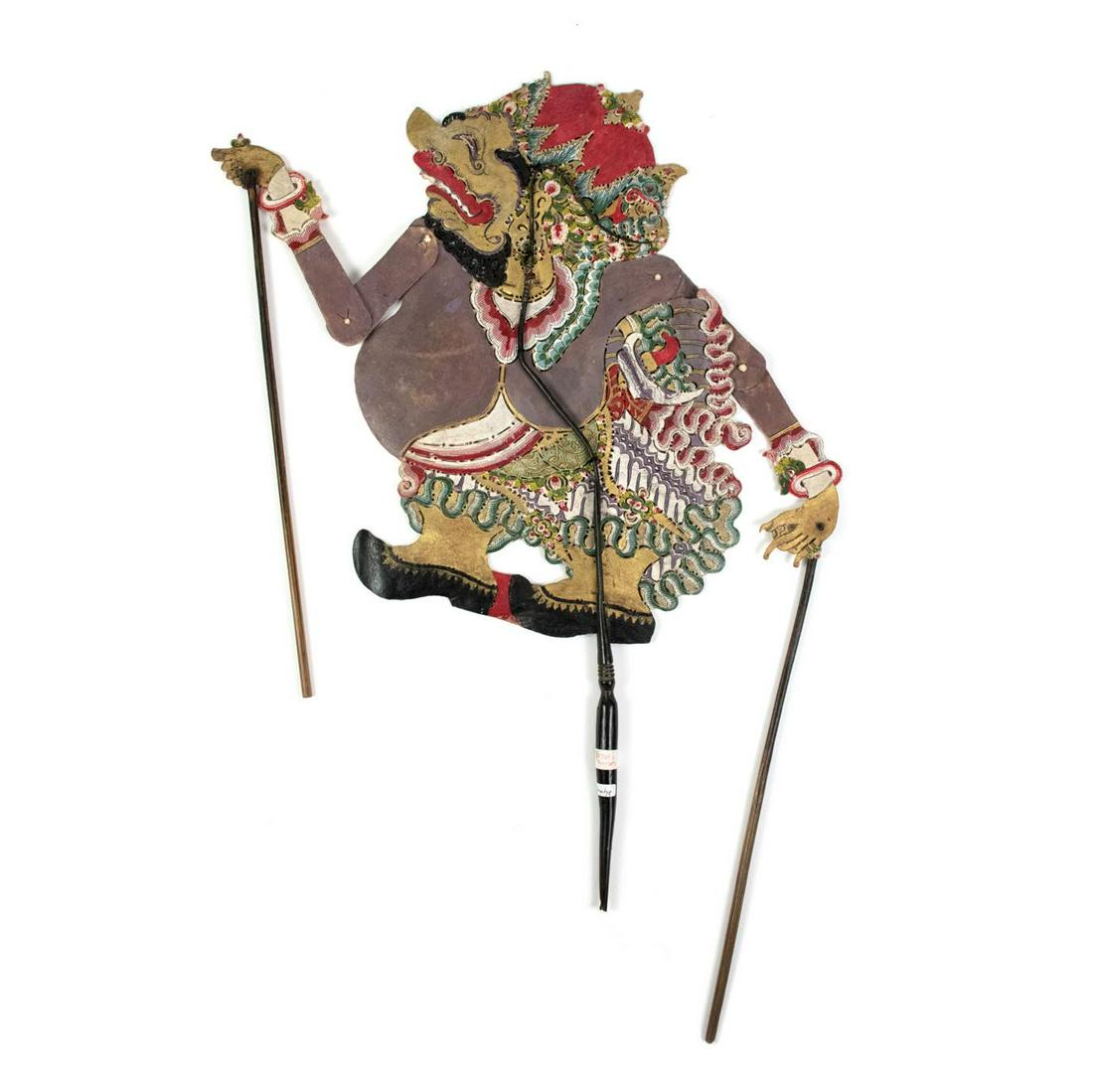 Indonesian Wayang Kulit Betara Harada Shadow Puppet: An Indonesian Wayang Kulit flat puppet (1900) intricately hand painted on leather hide. The character Betara Harada is depicted with a gold body, long sleeve tunic and intricate skirt detail. The pupp