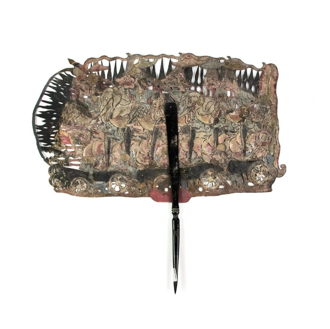 Indonesian Wayang Kulit Large Battle Shadow Puppet: A large scale Indonesian Wayang Kulit flat puppet intricately hand painted on leather hide depicting a battle scene with several male figures riding horses and elephants at the top, while men with can