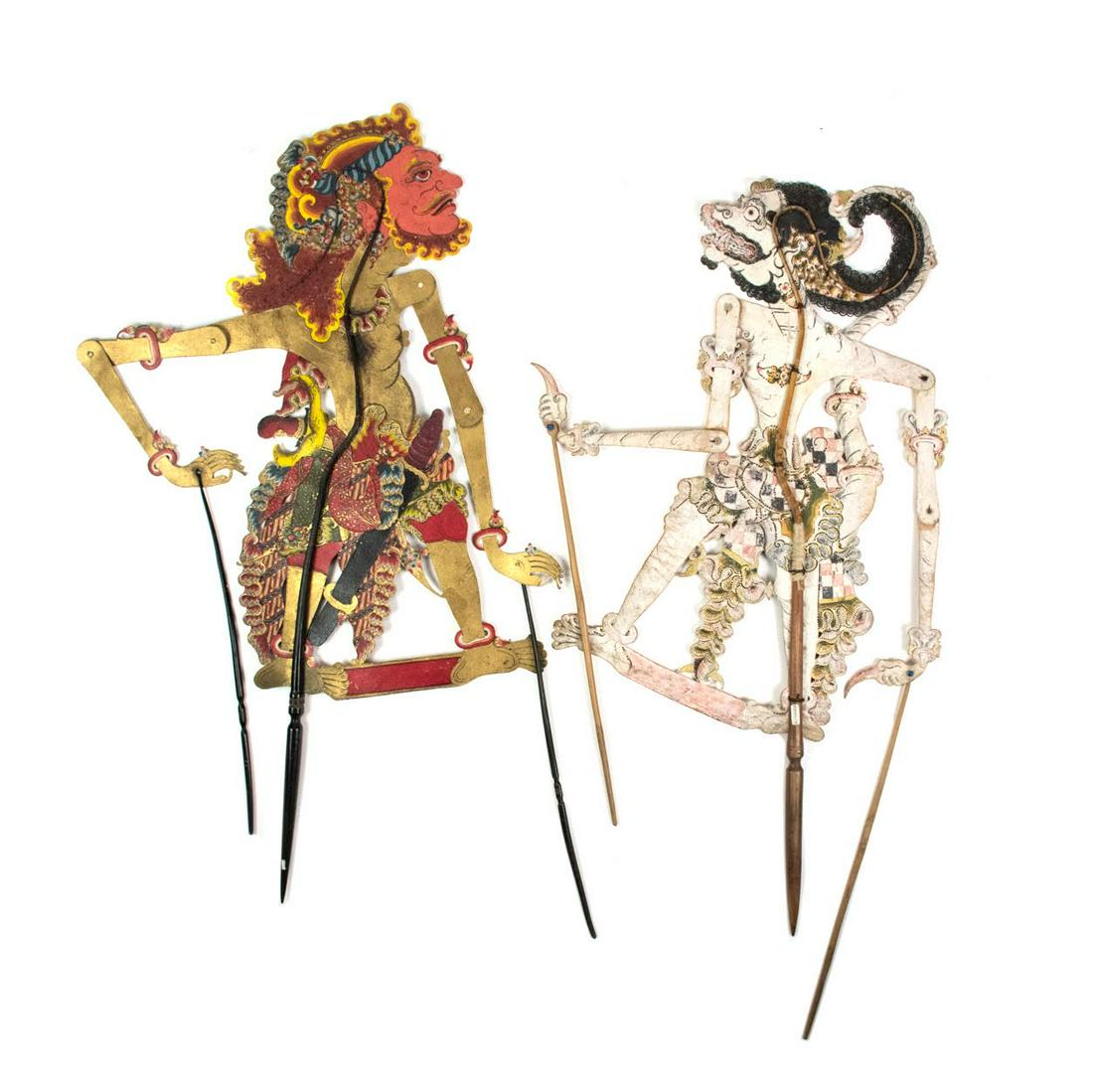 Two Indo Wayang Kulit Singo Matuta & Hanuman Puppets: A set of two Indonesian Wayang Kulit flat puppets intricately hand painted on leather hide representing characters Singo Matuta (left) from Kartasura c.1960 and Hanuman (right) from Sragen c.1930. Eac