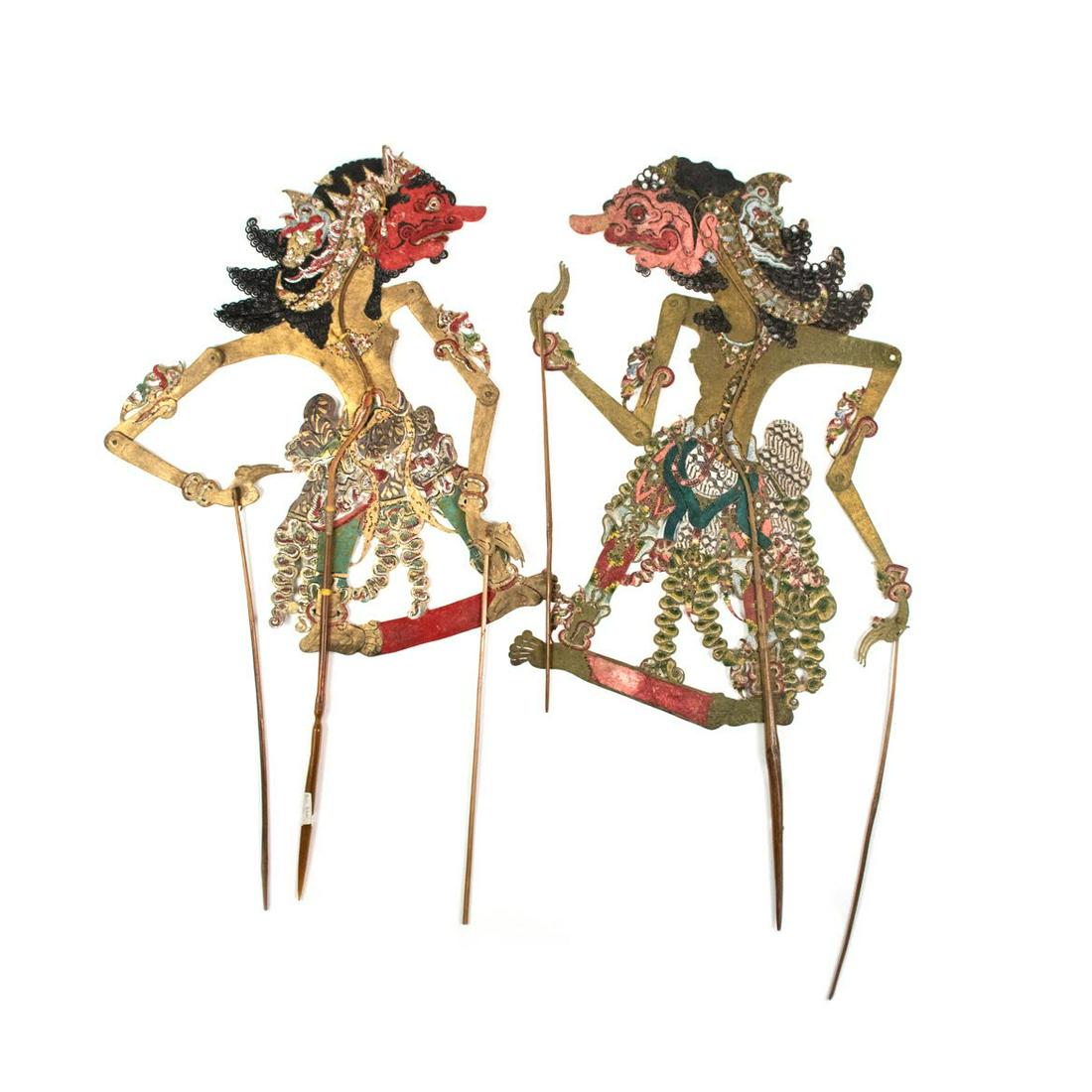 Two Indonesian Wayang Kulit Burisrawa Puppets: A set of two Indonesian Wayang Kulit flat puppets (c.1900) intricately hand painted on leather hide representing characters Burisrawa, both from Brebes. One has a red face and the other has a pink fac