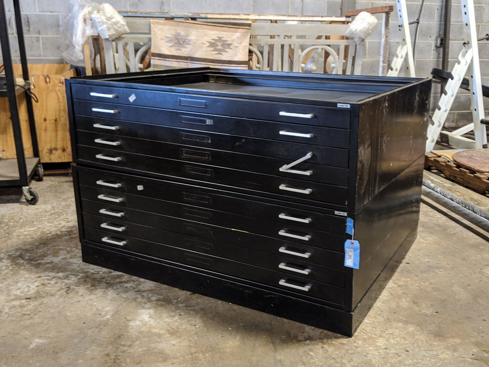 A Hamilton Black Steel Portfolio Flat File Cabinet: A Hamilton black steel portfolio flat file cabinet having two section and each section having five drawers. The drawers each have protective sleeves inside.Each section is 15.5" tall.