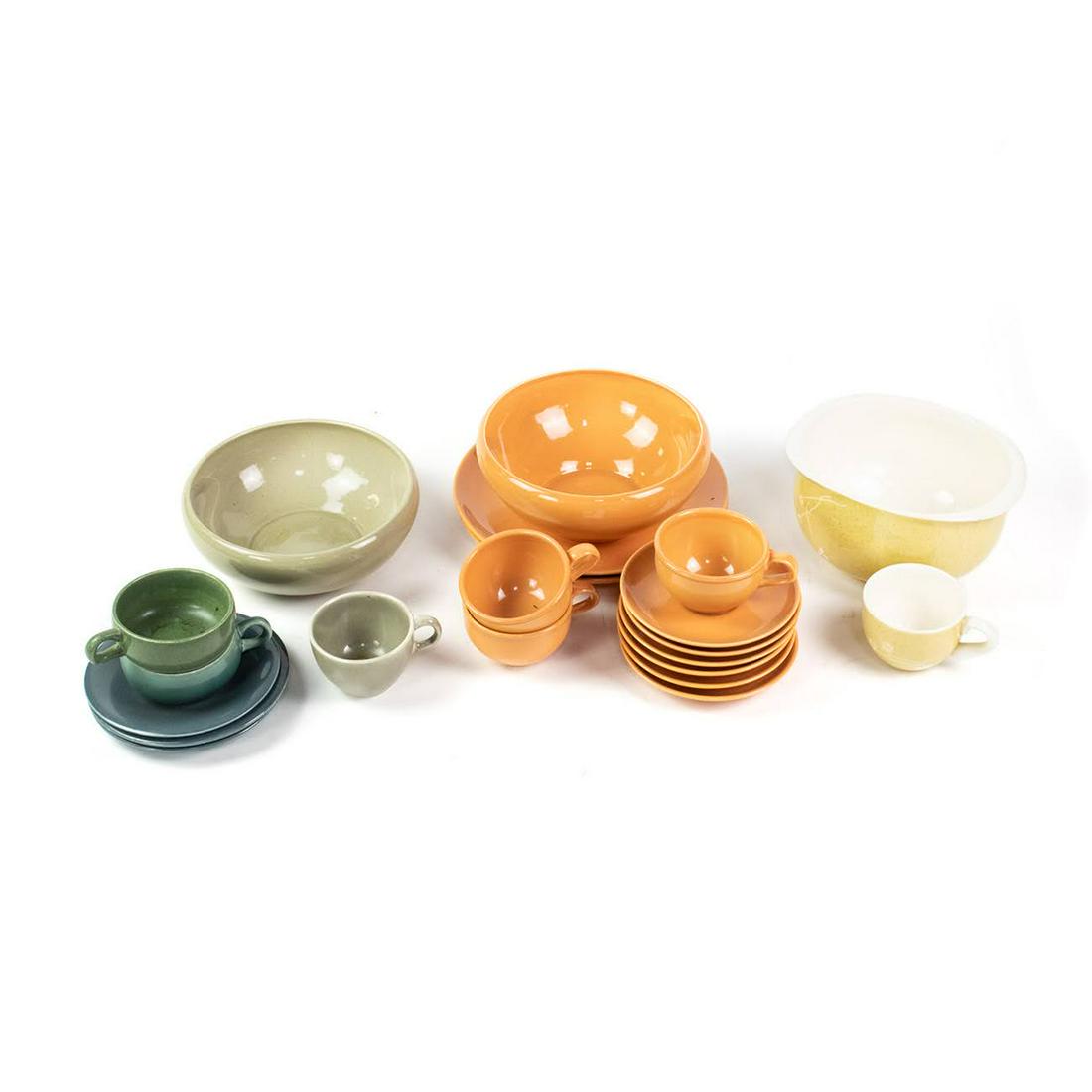 Group of Assorted Russel Wright Dishware Sets: A group of assorted Russel Wright dishware including Iroquois Casual Avocado Yellow recessed casserole dish and flat cup, Casual Cantaloupe 3 flat cups, 6 flat saucers, 2 dinner plates and a recessed