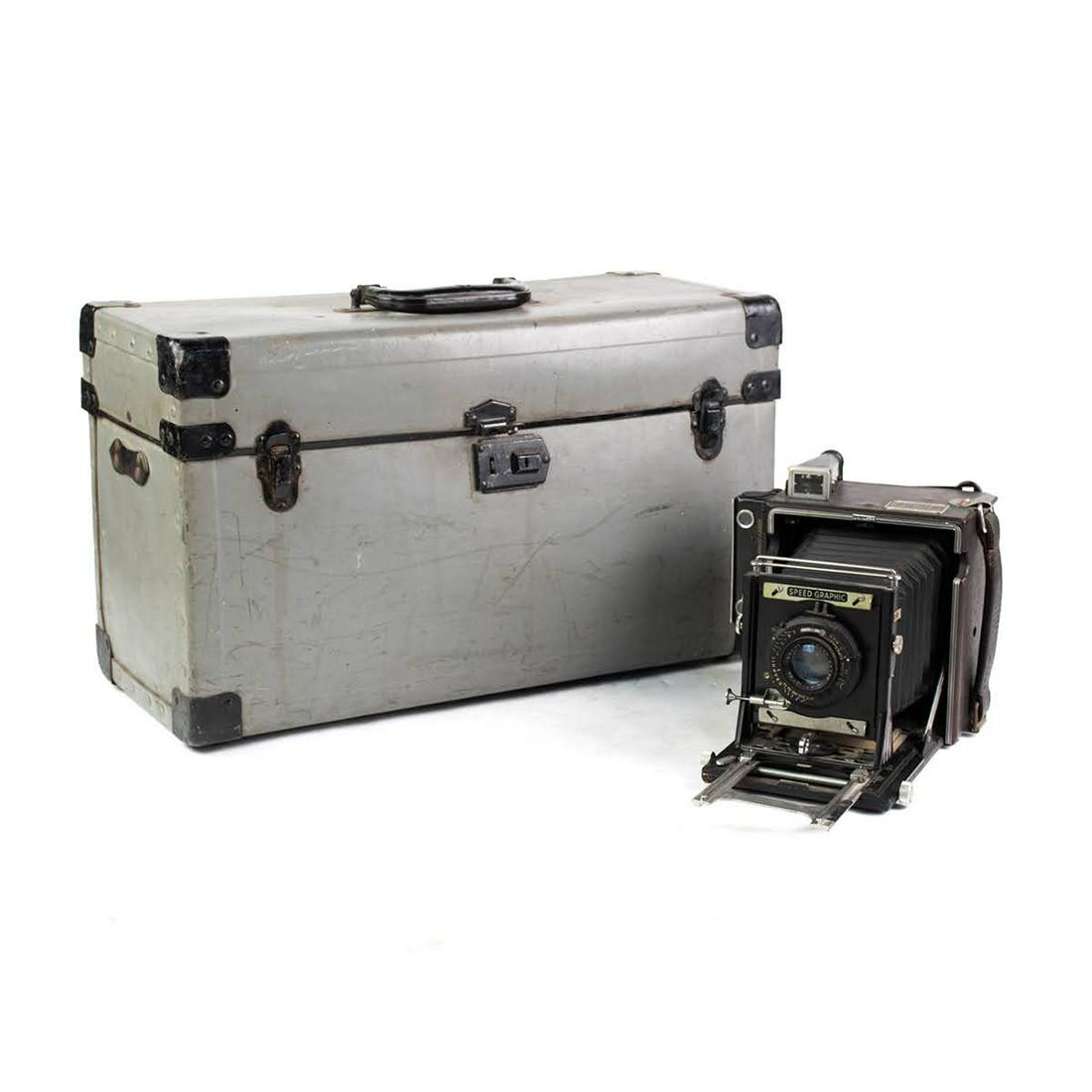 Graflex Speed Graphic Camera w/ Kodak Ektar 121mm F/4.7: A Graflex Speed Graphic 4x5 Large format field camera with Kodak Ektar 121mm F/4.7 lens and metal carrying case including additional light bulbs, slides, and strap.