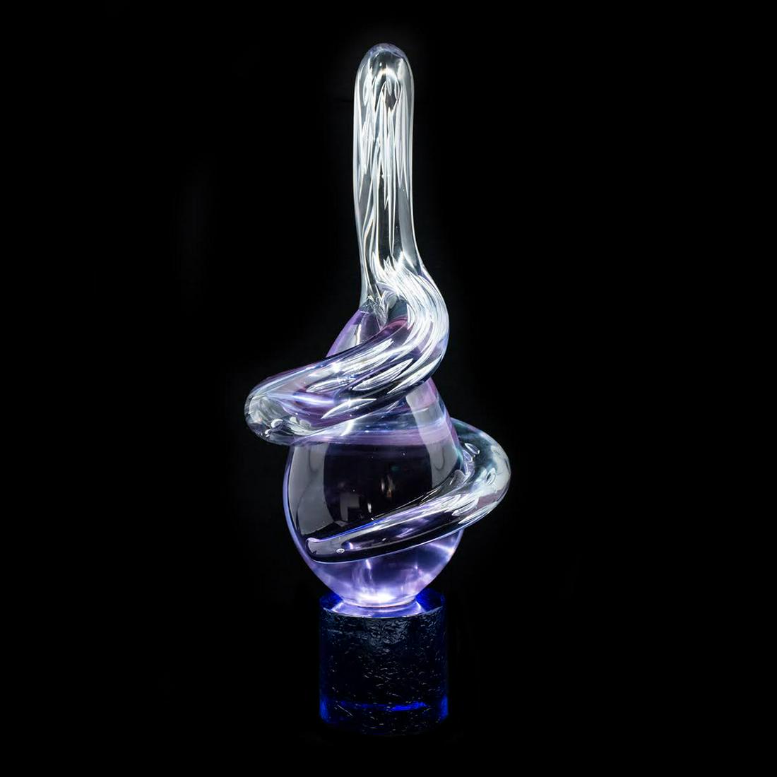 Large Art Glass Teardrop Sculpture: A large purple and clear glass teardrop form with dark purple cylinder base sculpture. Under different lighting the base color appears blue or purple. Signed illegibly on base.
