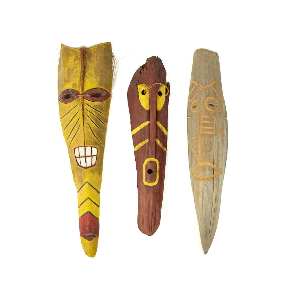 Group of 3 Decorative Aboriginal Wood Carved Masks: Group of 3 Decorative Aboriginal contemporary Wood Carved Masks including a yellow and red mask with string detail, red and yellow carved mask with string detail, and a wood carved mask with light col