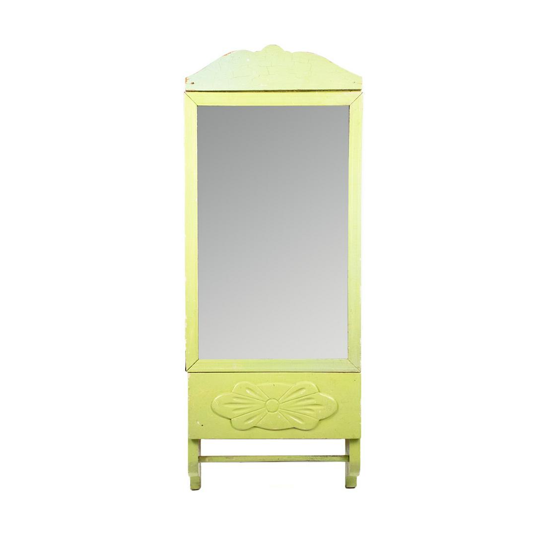 Antique Wood Carved Green Mirrored Medicine Cabinet: Antique wood carved mirrored medicine cabinet painted pale green with floral carved motif and dowel towel hanger at the bottom. Mirrored cabinet door opens to four interior shelves.