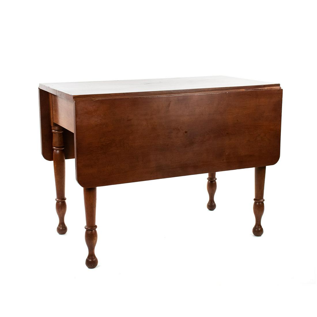 19th C. Early American Walnut Drop Leaf Dining Table: A 19th century early American walnut drop leaf dining table having two leaves at either side with rounded edges resting atop four turned legs. Unmarked.