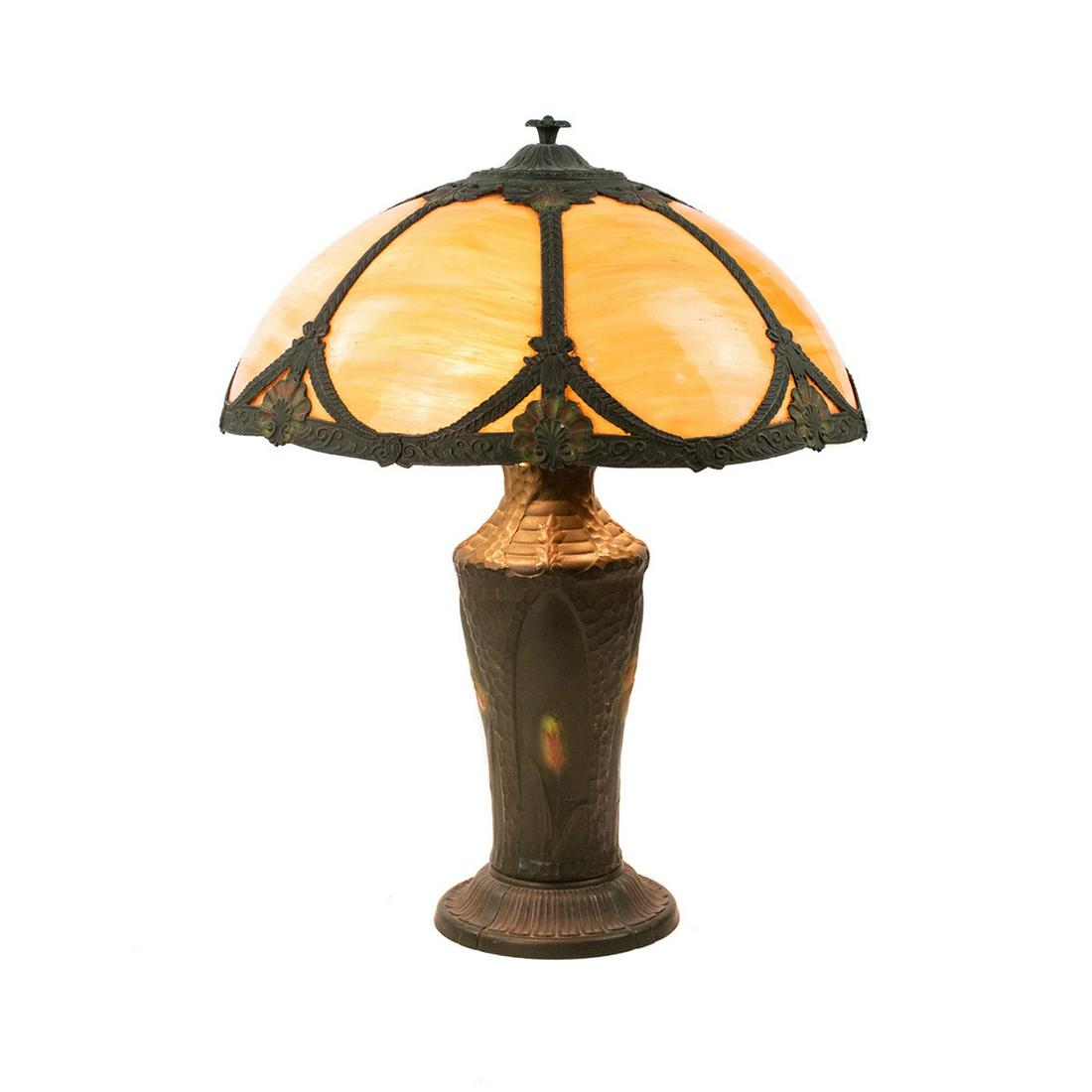 Antique H.E. Rainaud Art Nouveau Slag Glass Table Lamp: An antique H.E. Rainaud Art Nouveau slag glass shade table lamp having metal body with floral accents and 7 panel orange tone slag glass shade with matching floral motif. Features double bulbs and ori