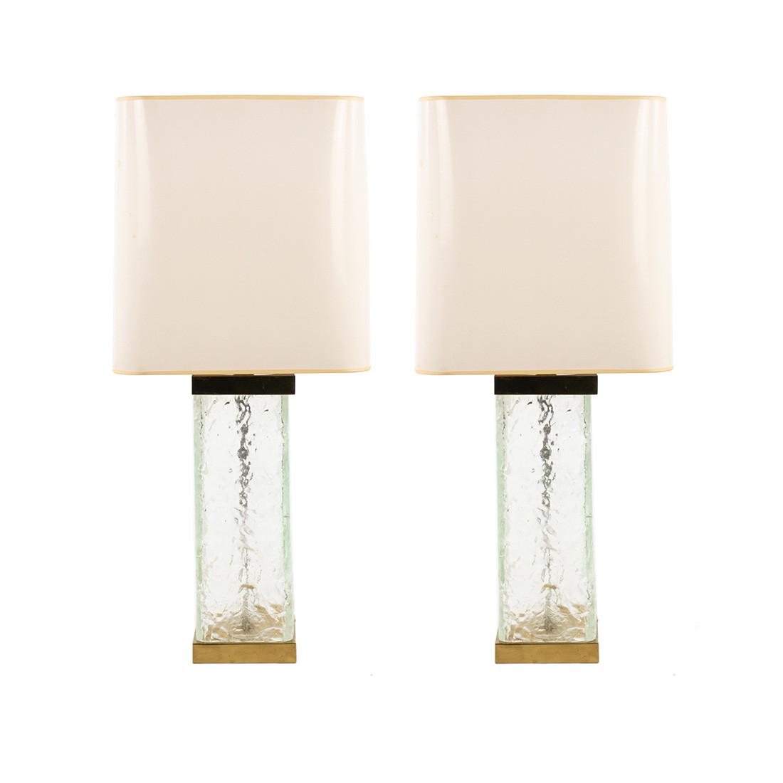 Pair of Paul Hanson Brass and Glass Table Lamps: Pair of Paul Hanson brass and glass table lamps having original shades, brass finials with frosted, rectangular glass pillar bodies topped with original white and gold accented shades. Stickered 'Made
