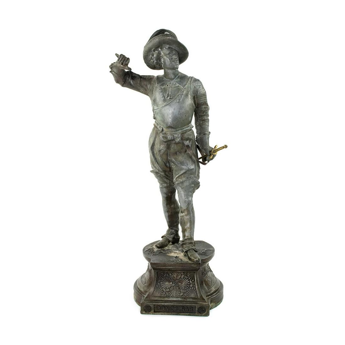 19th C Don Cesar Spelter Cast Musketeer Statue: A 19th Century cast metal spelter figural sculpture depicting Don Ceasar a spanish musketeer with sword and standing on metal plinth with title.