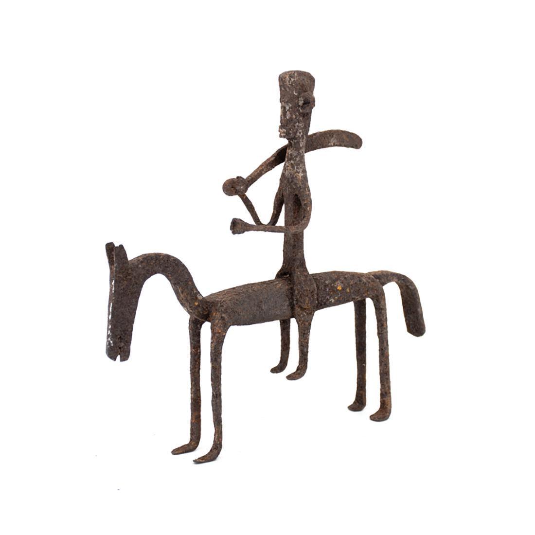 Bamana Style Iron Horse and Rider Figure: An African Mali Bamana style iron horse and rider figure (possibly 19th century) depicting man riding horse with large sword.