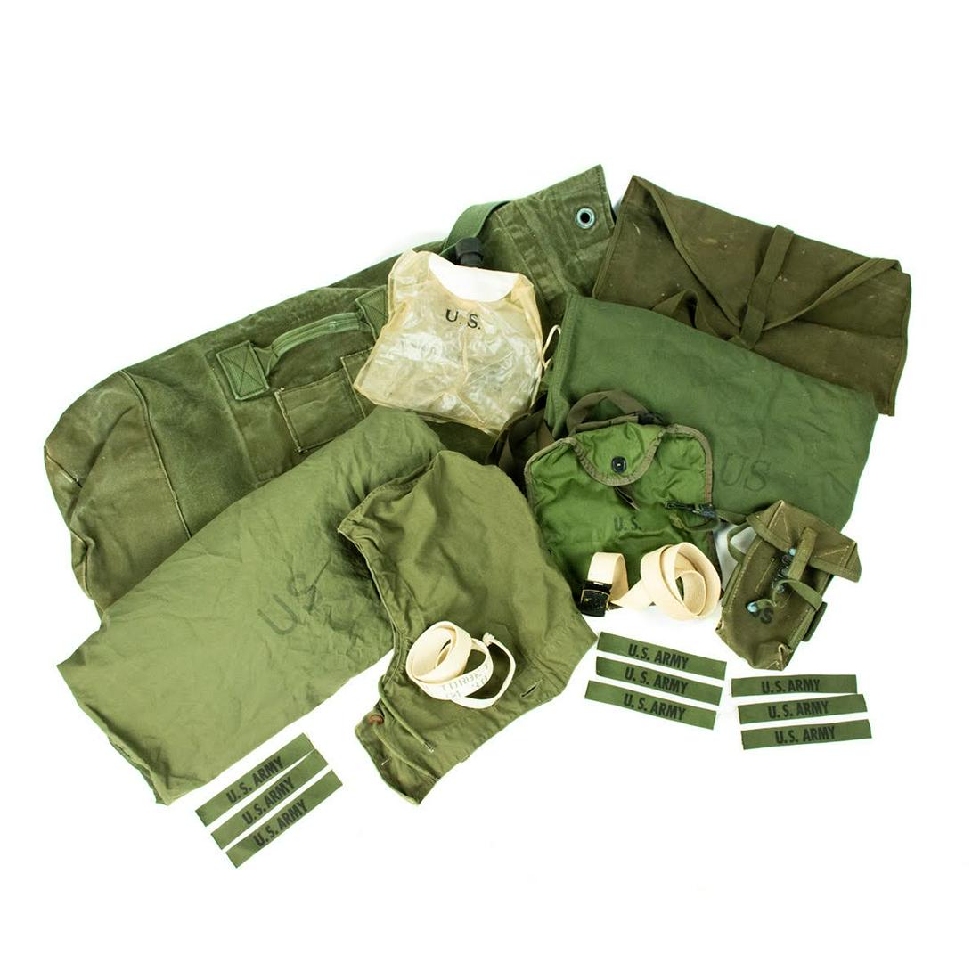 50-60's Era US Army Rucksack and Accessories: A grouping of 50-60's US Army rucksack and various gear including a large Army rucksack marked Gary A. Maynard, a clear water bag, a US green nylon canteen, green holster, green canvas pouch, two draw