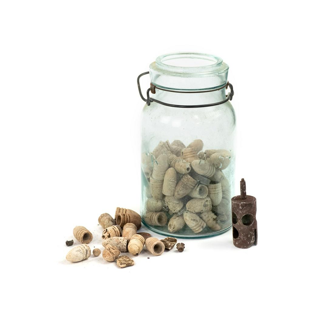 Group of US Civil War Minie Balls and Other Bullets: A tall blue glass jar of bullets and other components in various sizes and materials. Recovered in the 1990s. Provenance: Larry McCoy - Mobile, AL.