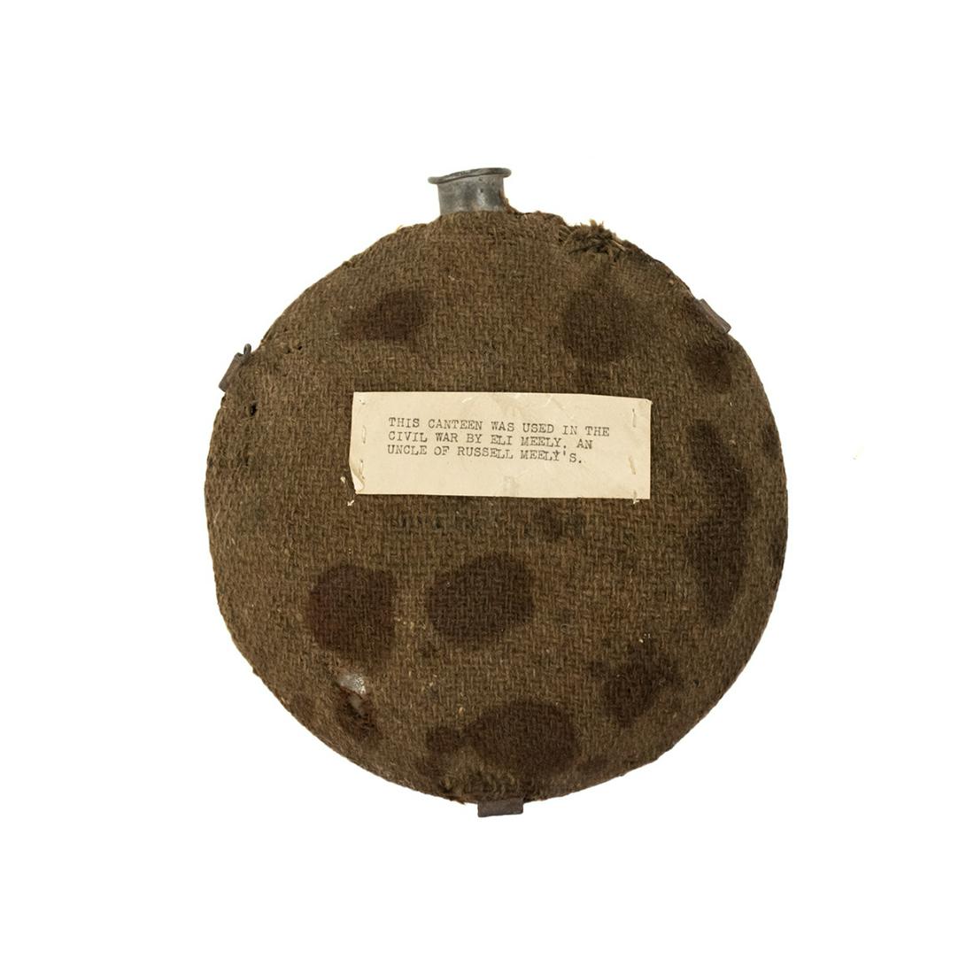 US Civil War Union Canvas Wrapped Canteen: A United States Civil War era Union soldier's issued canteen in canvas cover with paper reading "This canteen was used in the Civil War by Eli Meely, an Uncle of Russell Meely's."