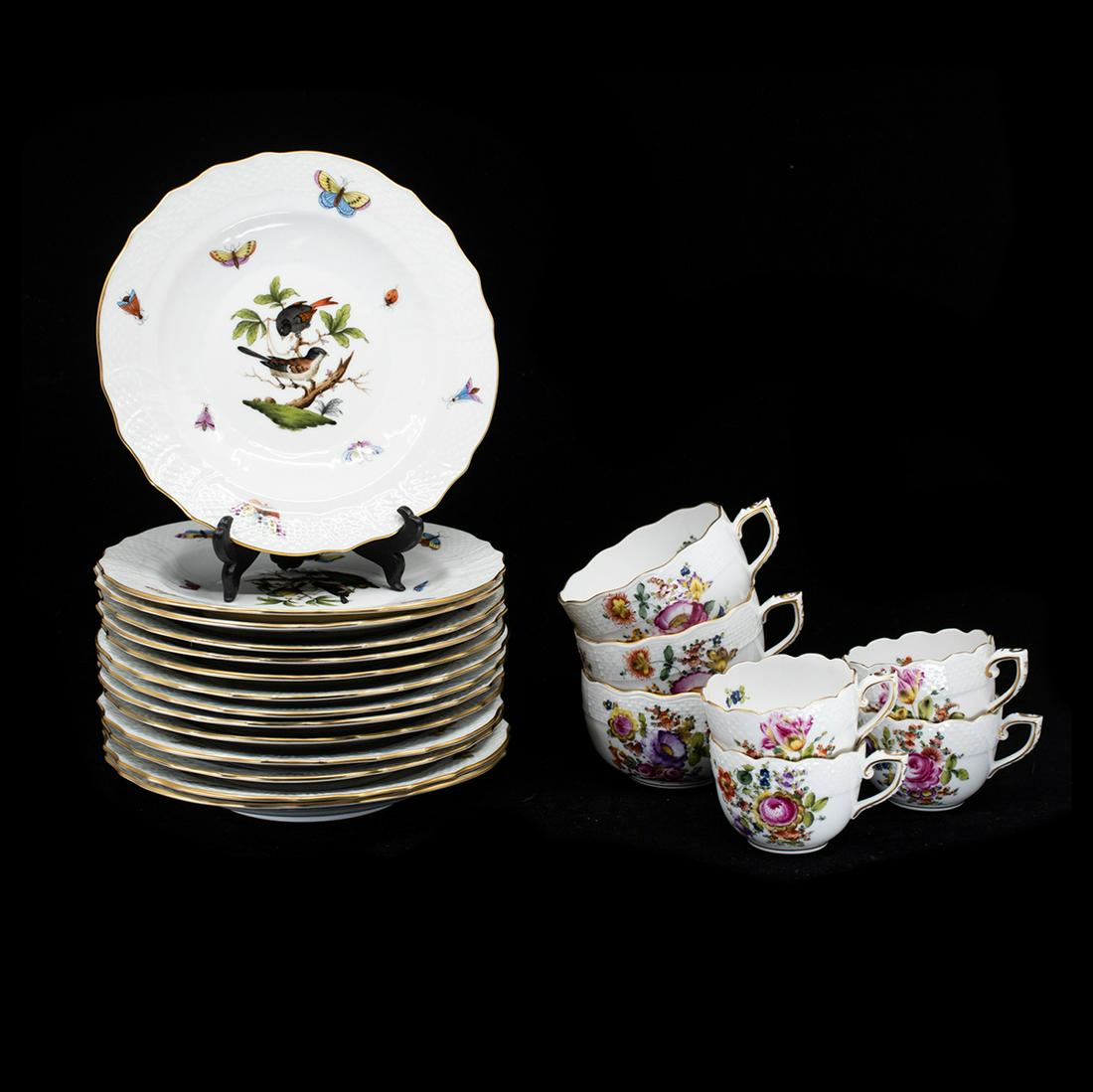 Herend Hungary Porcelain Plates and Tea Cups: A grouping of vintage porcelain china by Herend Hungary. This lot includes thirteen "Rothschild" plates, three coffee cups, and four teacups. Each plate features a hand-painted bird motif in the cente