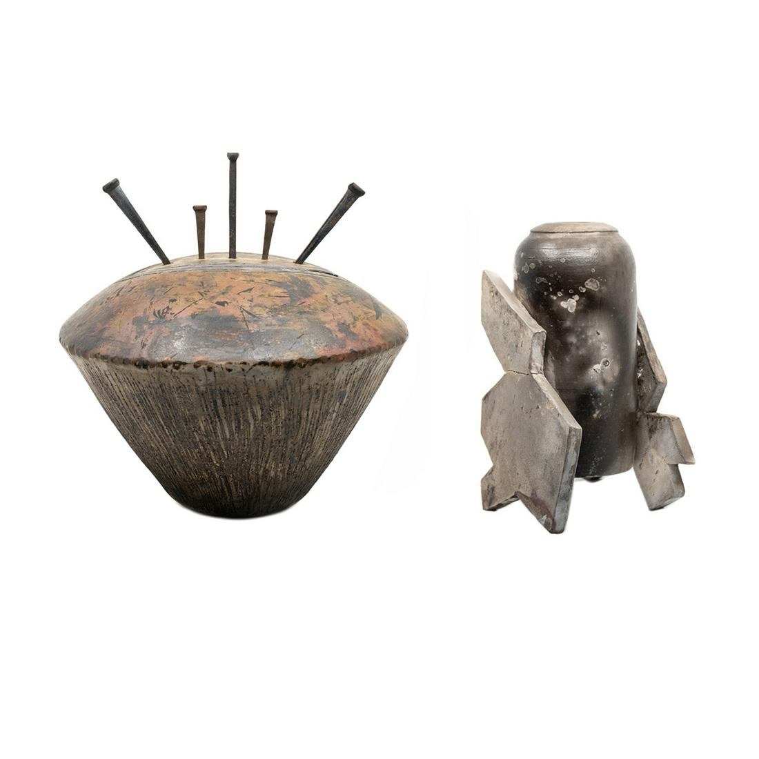 Group 2 Brutalist Style Raku Pottery Vase and Vessel: A group of two Brutalist style Raku pottery vessels including a lidded vessel with nail handle and diamond cut out and a blackened vessel having two abstracted forms as the supports. Lidded vessel is 