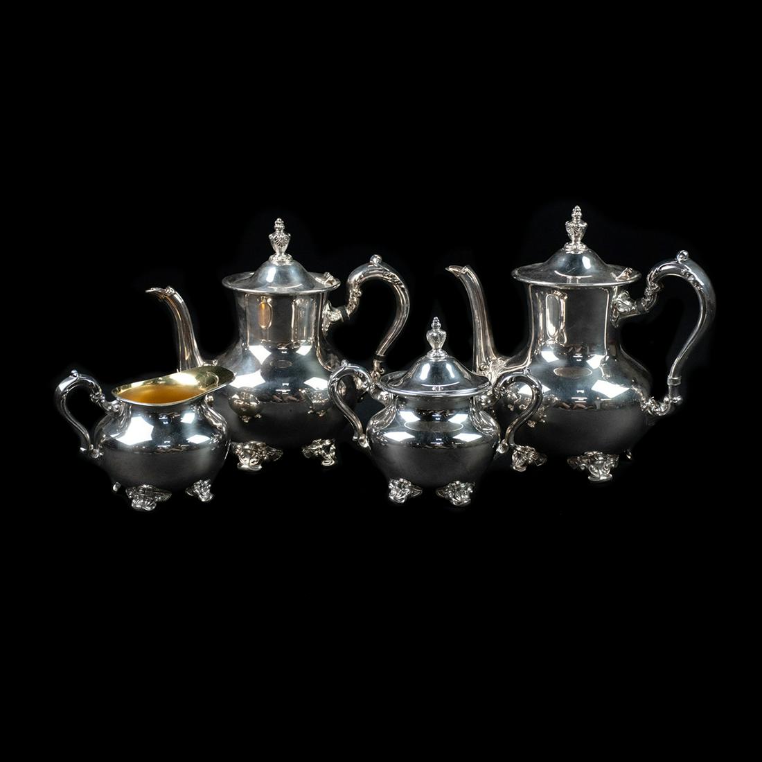 Antique Poole Silver-Plated Tea & Coffee Service: An antique silver-plated tea and coffee service by Poole Silver Company. This four-piece set includes a coffee pot, teapot, creamer, and lidded sugar dish. Each is marked "E.P.N.S. Silver Plate Poole 