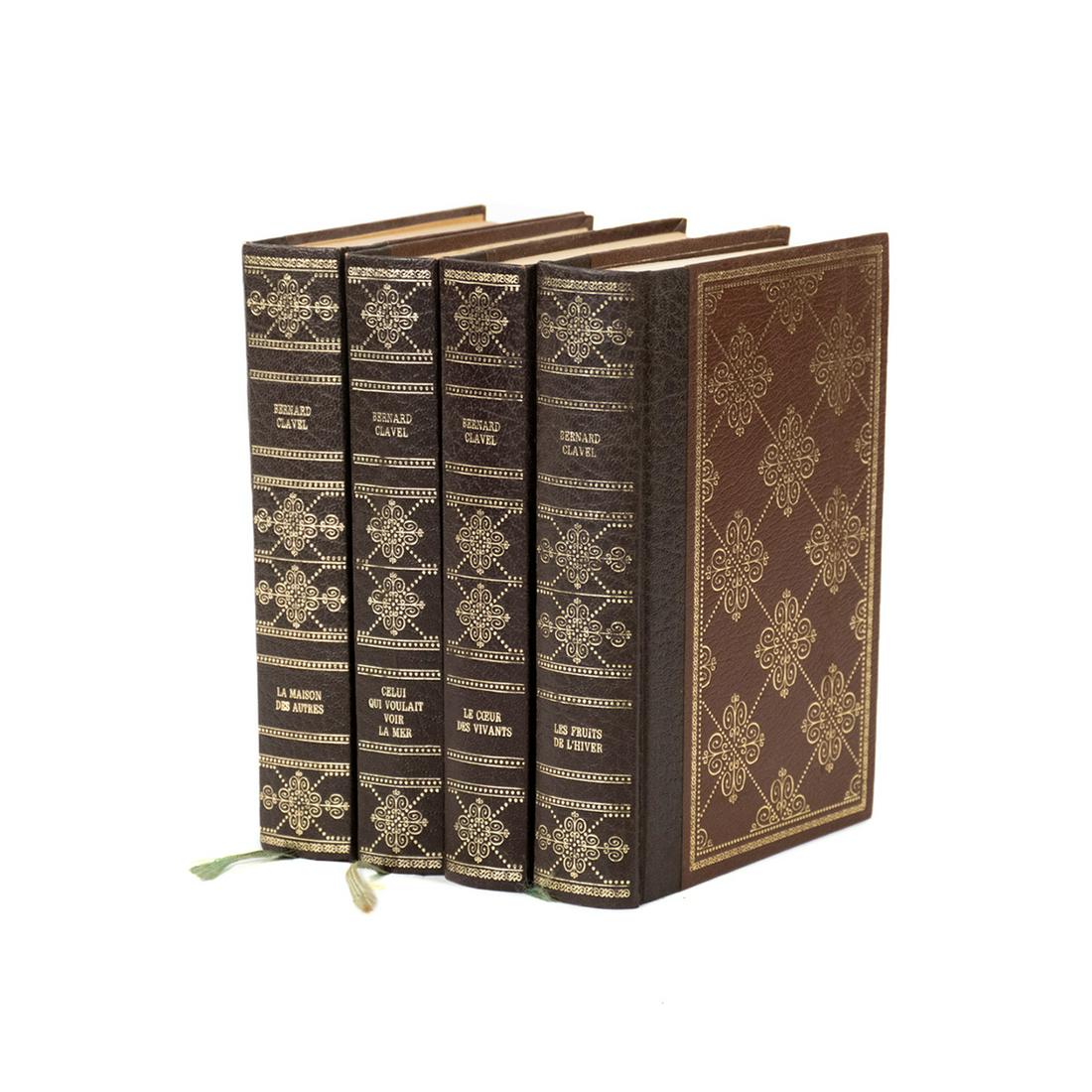 Bernard Clavel 4 Volume Brown Leather Bound Books: An Oriental Accent red porcelain and bronze finish bird motif punchbowl having a red crackle bowl with bronze fitted rim and heron or swan handles. It rests atop an orante bronze finish base. Marked o