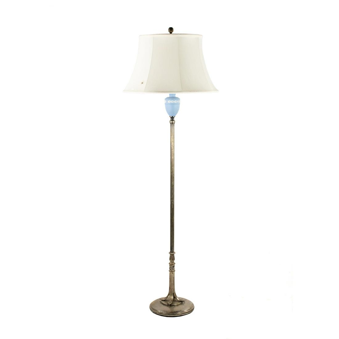 Wedgwood Blue & White Jasperware Torchiere Floor Lamp: A 20th century Wedgwood Jasperware torchiere floor lamp having mounted blue and white embossed urn. It features a silver-tone metal construction featuring a column style body with ornate decorated rou