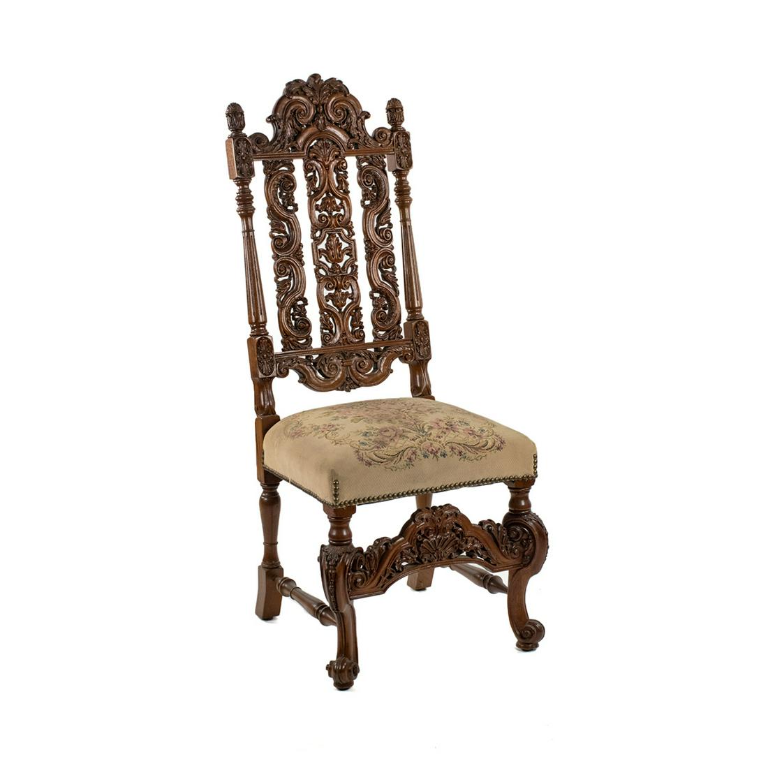 Renaissance Revival Chair with Needlepoint Seat: An antique Renaissance Revival carved side chair having a carved foliate motif back, petit point seat covering floral design over a cream base and is secured with a brass tack edge. This piece is rais