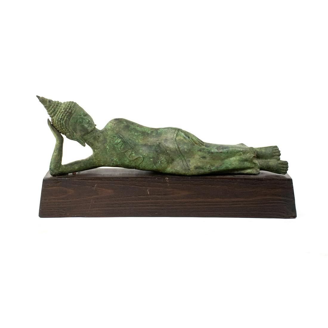 Bronze Reclining Buddha Sculpture on Wooden Base: A vintage bronze reclining Thai Buddha sculpture mounted on a wooden base. It is unmarked.