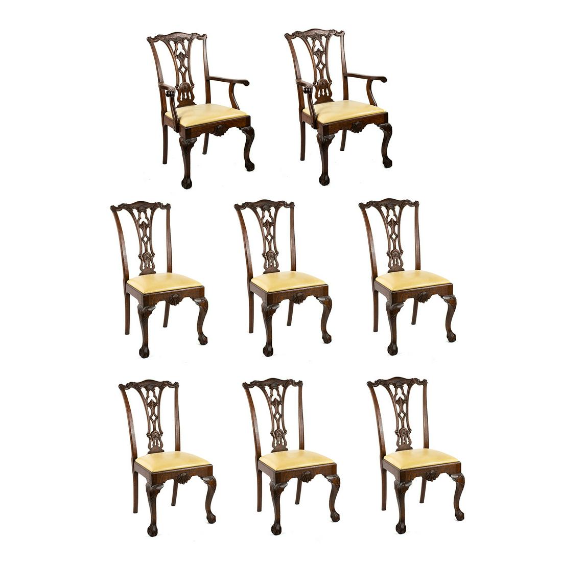Set of 8 American Chippendale Oak Dining Chairs: A set of eight antique Chippendale style American oak dining chairs featuring carved wooden frames and pale yellow leather upholstered seats. This set includes two armchairs and six side chairs. They
