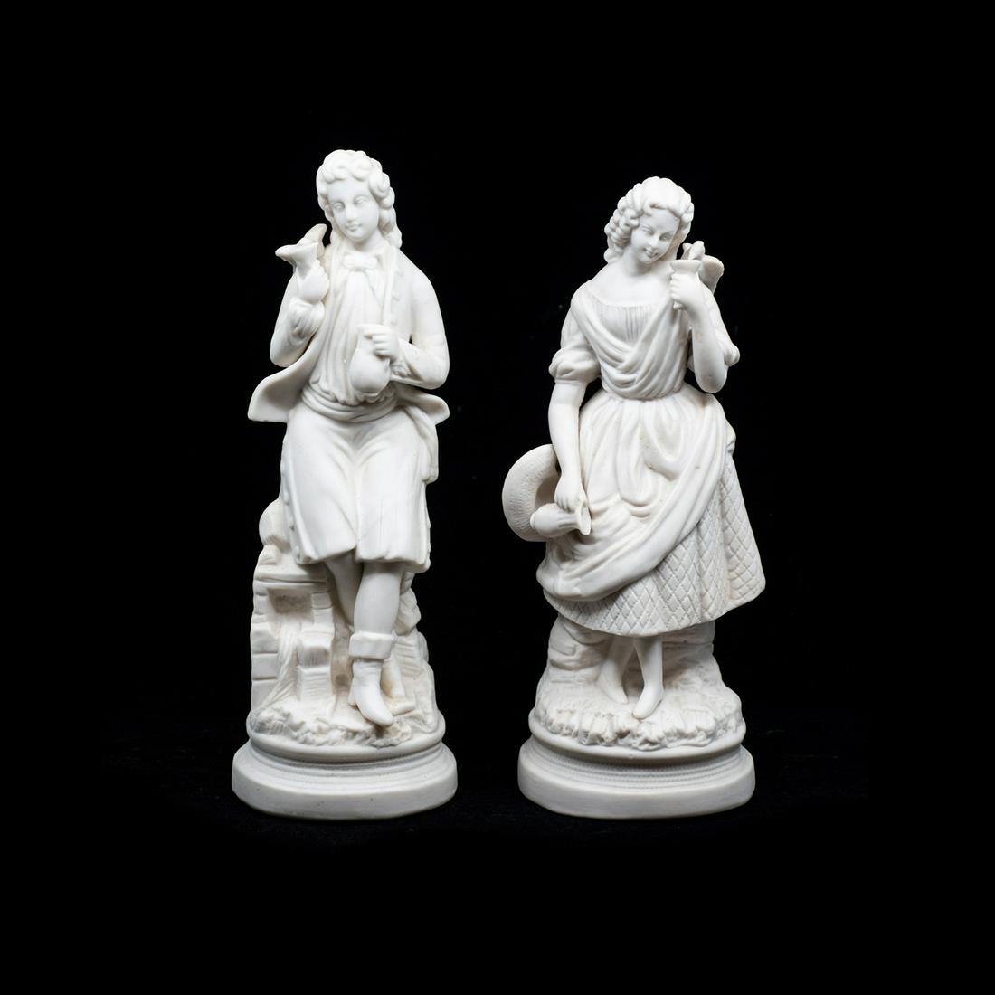 19th C. Parian Bisque Sculptures: A pair of two 19th century antique parian bisque porcelain sculptures, including a man and a woman each depicted holding a glass and pitcher. They are unmarked.