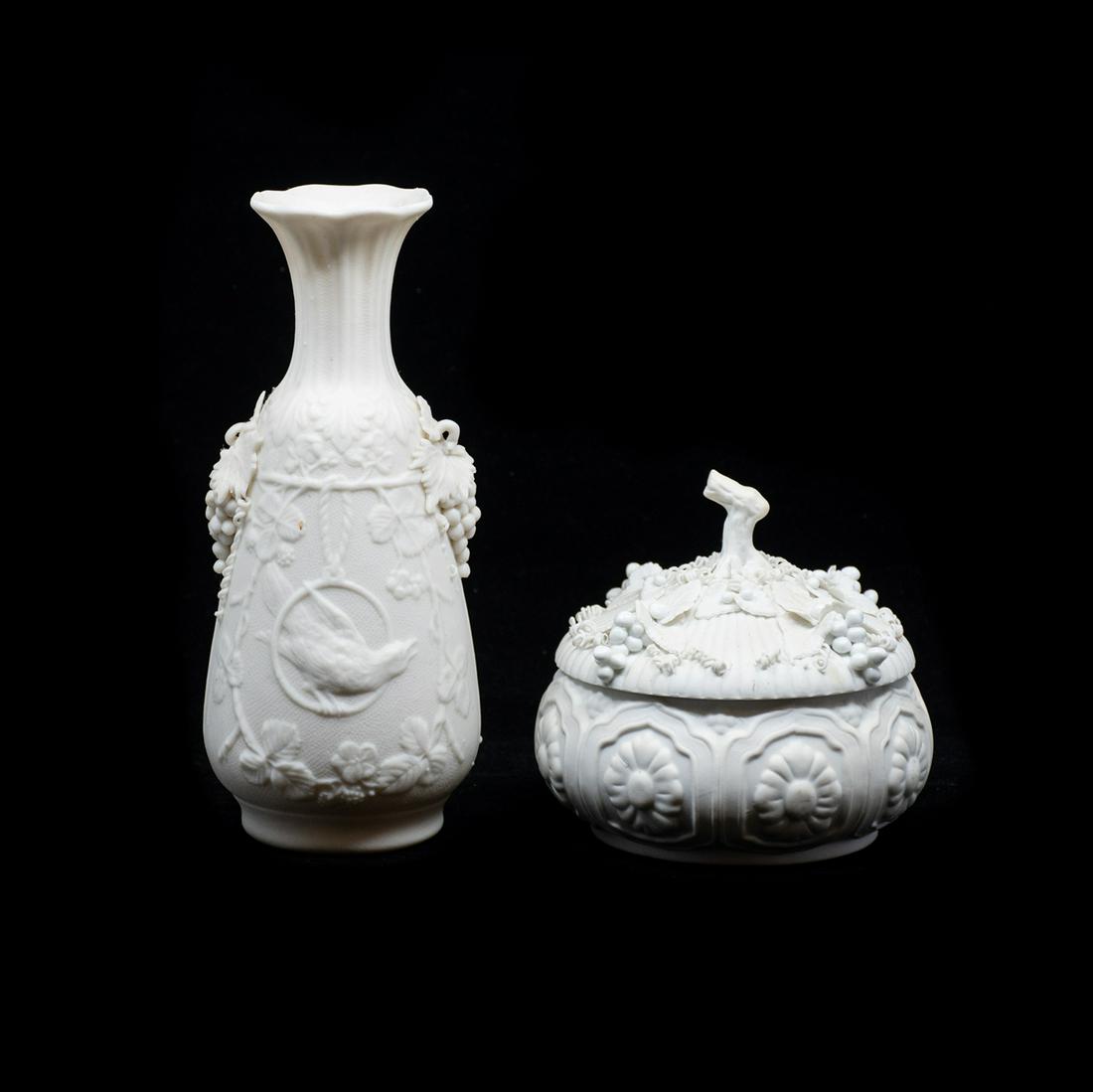 19th C. Parian Bisque Pieces: A grouping of two 19th century antique parian bisque porcelain pieces, including a bird and floral motif vase and a harvest-themed covered dish. They are unmarked.