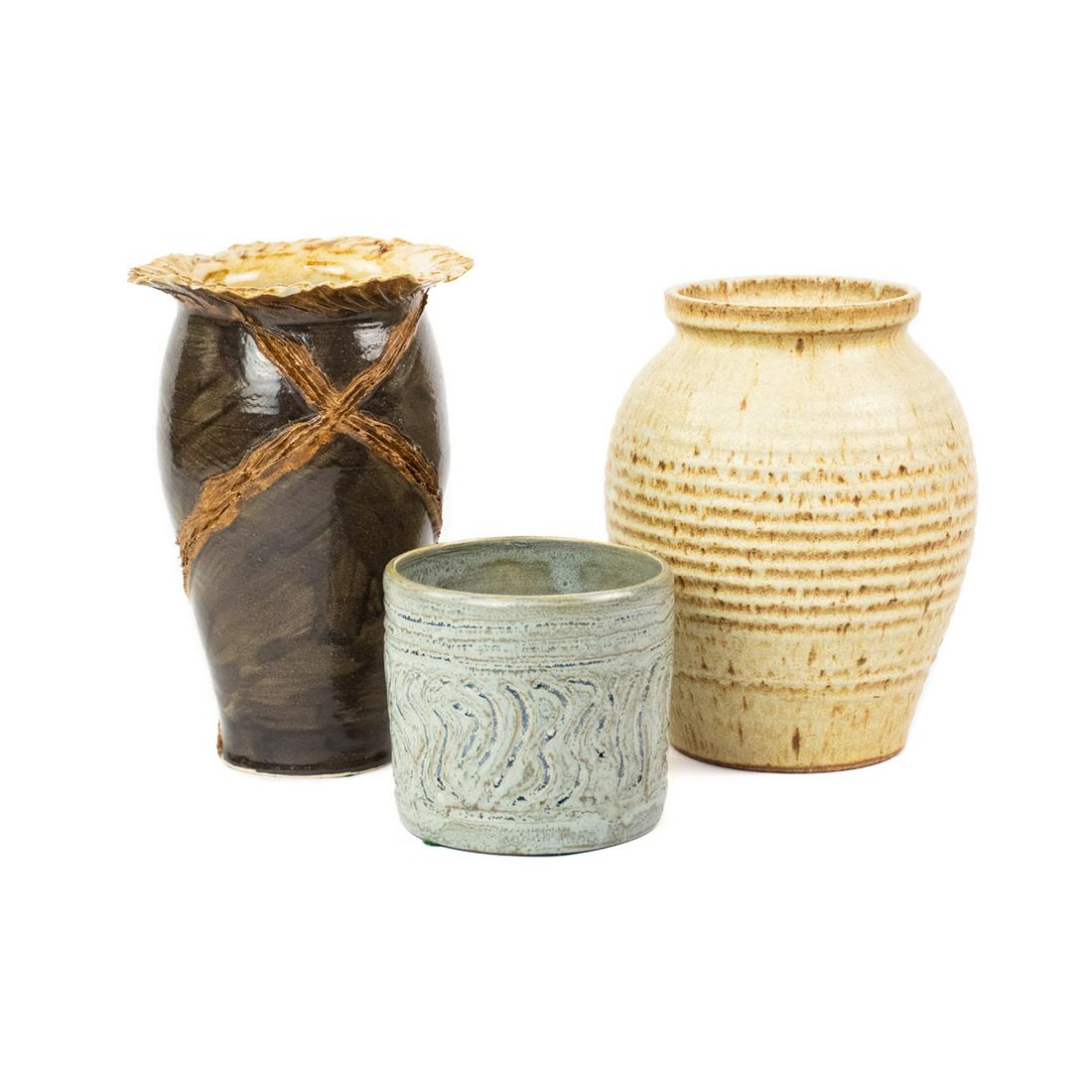 Grouping of Signed Art Pottery Vases: A grouping of three art pottery vases, including a brown vase signed "Heyward 94", a light blue vase signed "NB 04", and a cream and tan vase by Jean Paul Stowe of Vermont signed "Jean Paul Stowe VT".