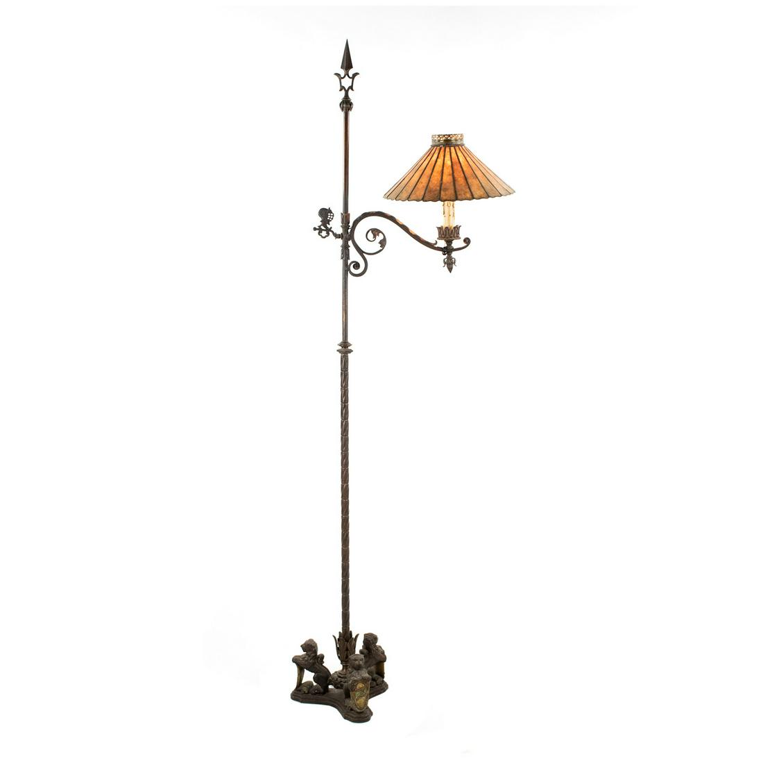 Crest Lighting Co. Spanish Revival Bronze Floor Lamp: A vintage Spanish Revival bronze floor lamp by Crest Lighting Co. featuring a spear form with a curved arm that extends outward to support a faux candle socket covered by a conical orange stained glas
